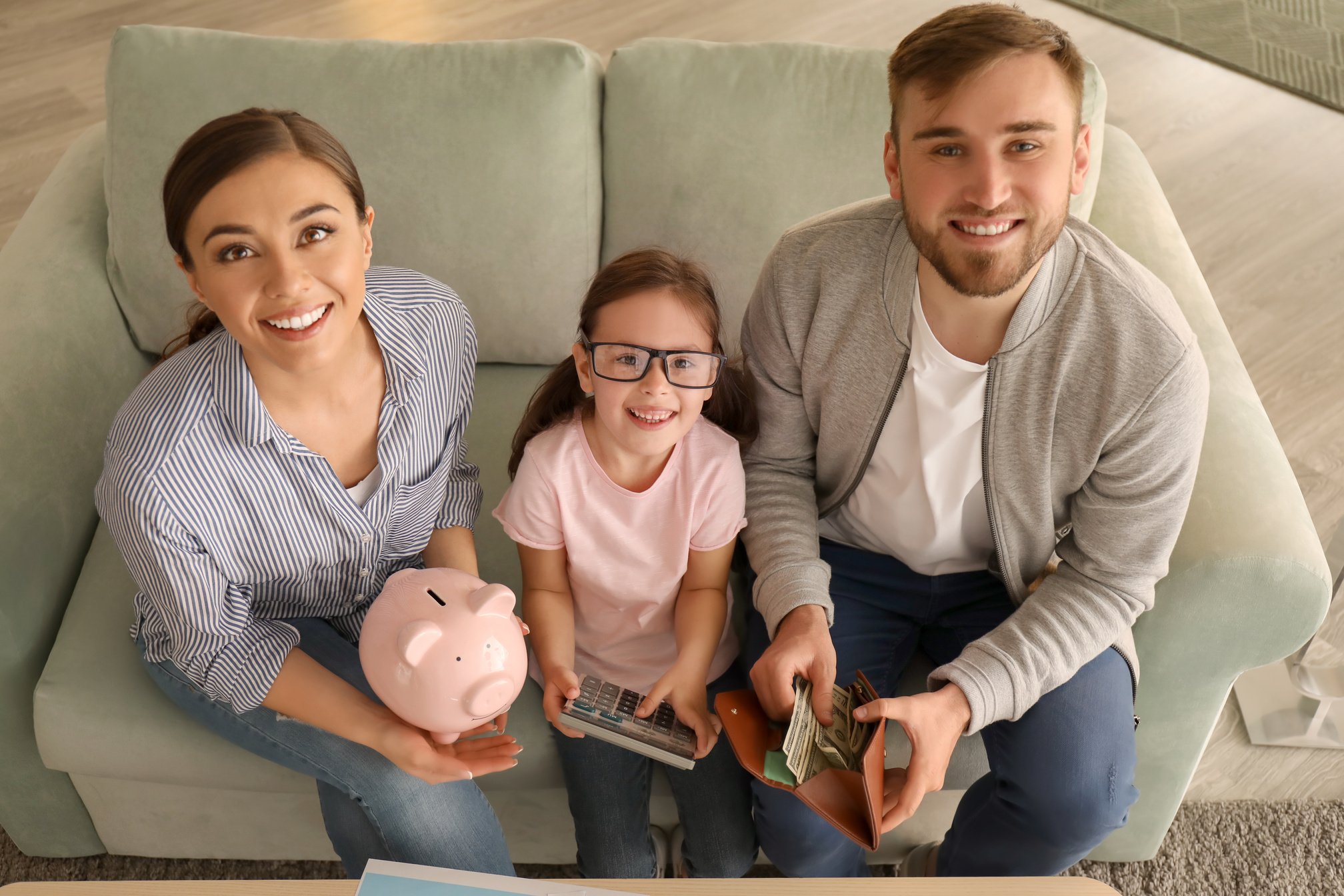 Happy Family Counting Money Indoors. Money Savings Concept