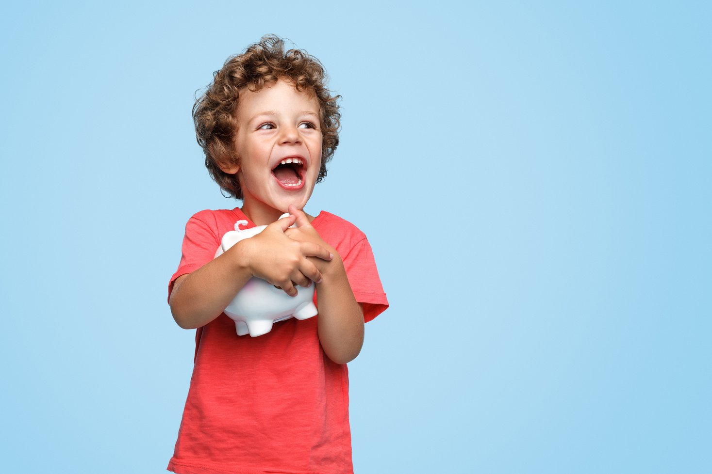 Excited kid with piggy bank