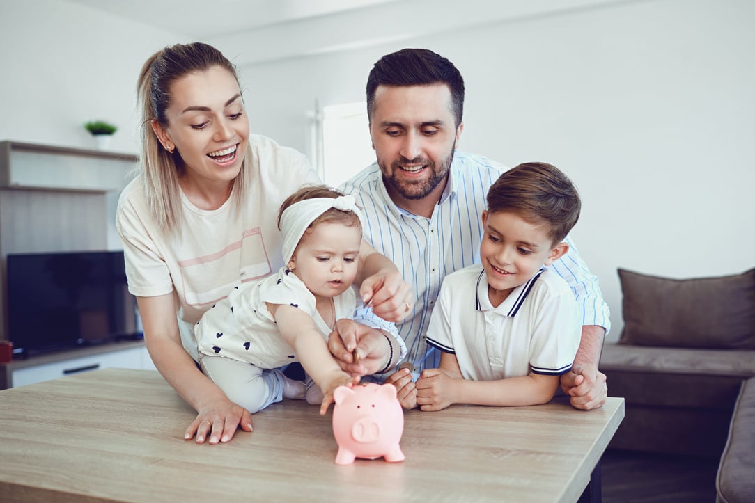 A Smiling Family Saves Money with a Piggy Bank.